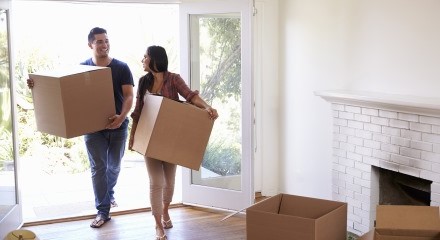 Couple carrying boxes