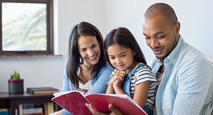 Family looking at notebook