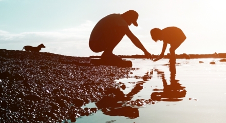 Parent and child exploring river